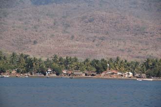 AMI Lombok Ombak Putih sailing ship in Labuhan Kayangan harbour Menangabaris village on the coast with mosque 3008x2000