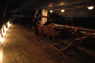 AMI Lombok Senggigi Ombak Putih open air dining table by night 3008x2000