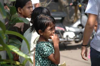 AMI Lombok Taman Narmada Park little girl eating cookies 3008x2000